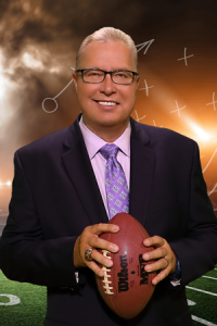 Former NFL and current CEO Ron "Jaws" Jaworski holding a football.