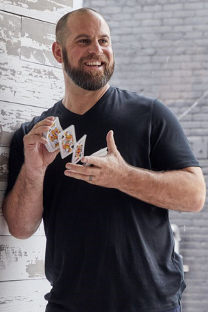 Magician Jon Dorenbos shuffling a deck of cards in his hands.