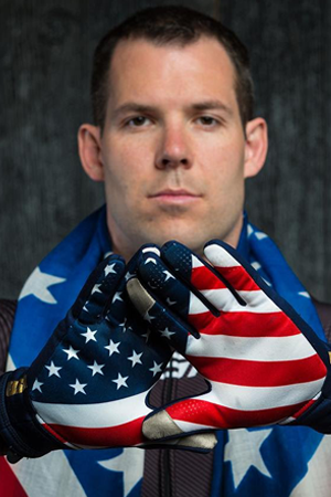 U.S. Olympian Johnny Quinn with an American flag draped around his shoulders.
