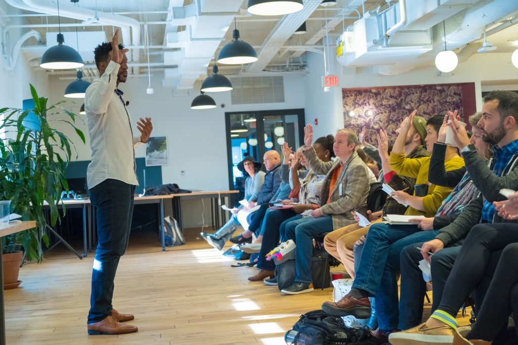 AK Ikwuakor giving a Keynote speech in front of an audience.