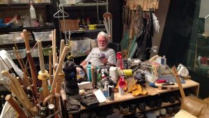 Foley Artist John Roesh sitting behind his desk surrounded by instruments