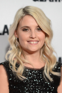 Erin Merryn in a black dress, smiling.