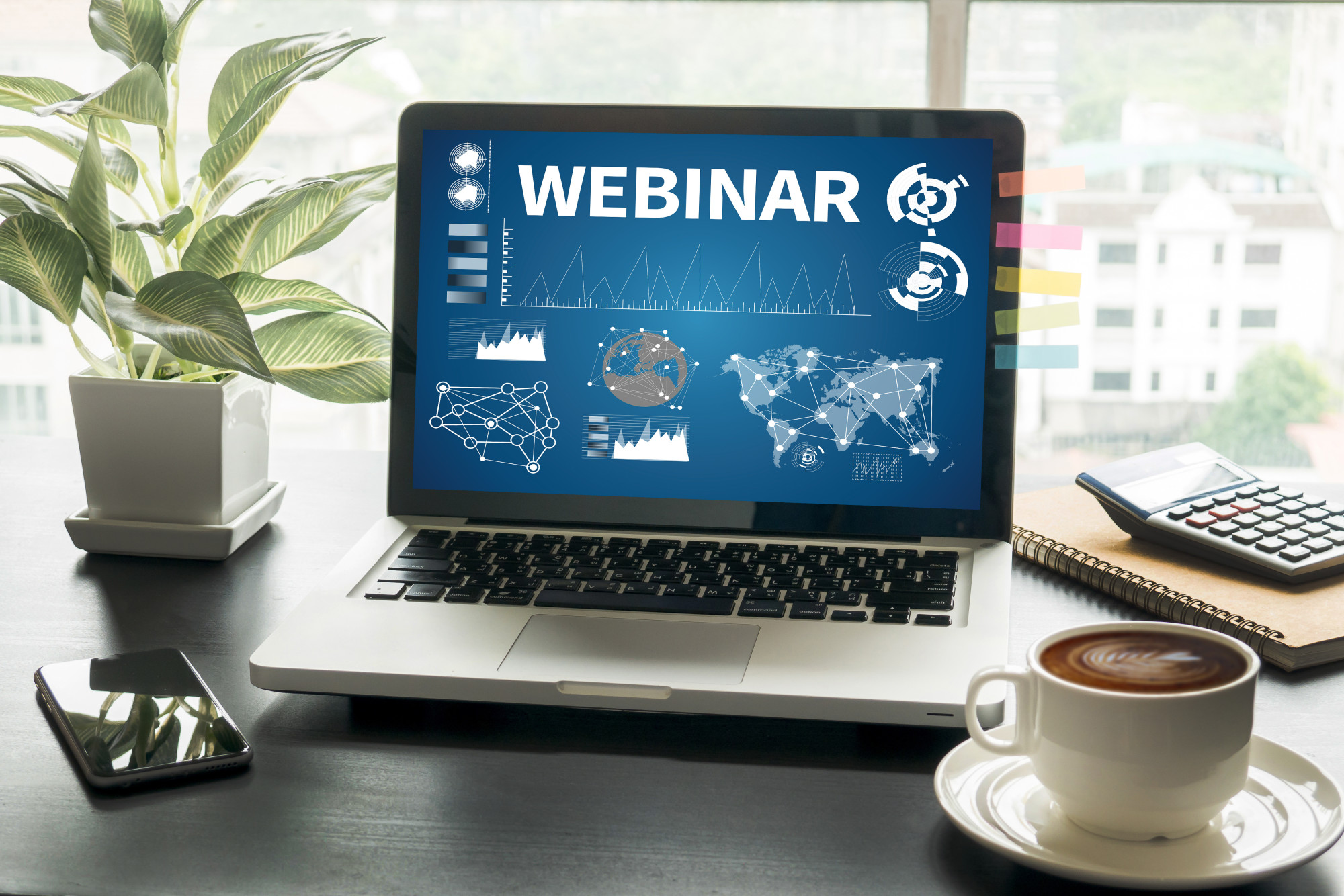 A laptop screen that displays "WEBINAR," an intro screen for a virtual event.