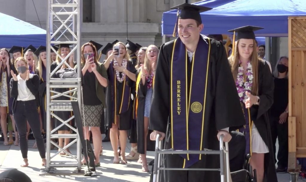 Robert Paylor walking at his graduation.