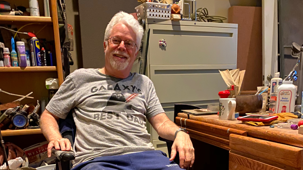 John Roesch posing for a photo in his Foley studio.