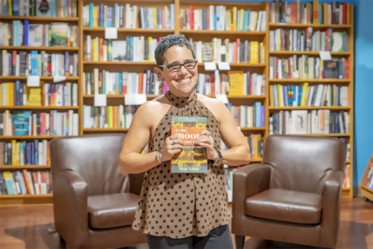 Motivational Speaker Lisa Kohn holding her book