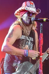 Bret Michaels on stage singing holding a guitar