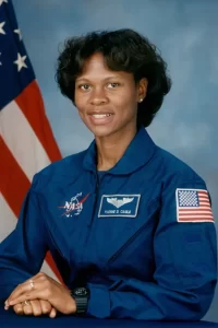 U.S. Astronaut Yvonne Cagle in front of an American flag.