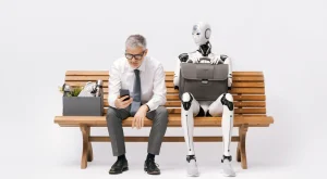 A man sitting next to an ai robot