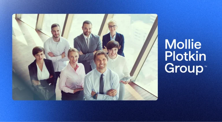 A sales team standing together smiling